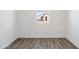 Bright bedroom features wood-look floors and window with view of the home exterior at 12246 E Agave Ln, Florence, AZ 85132