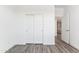 Bright bedroom features wood-look floors, white walls, and closet with sliding doors at 12246 E Agave Ln, Florence, AZ 85132