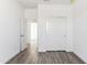 Bright bedroom featuring wood-look floors, a closet, and an open doorway at 12246 E Agave Ln, Florence, AZ 85132