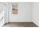 Bright bedroom featuring wood-look floors, a window with blinds and white walls at 12246 E Agave Ln, Florence, AZ 85132