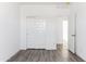 Bright bedroom featuring wood-look floors, closet, and doorway at 12246 E Agave Ln, Florence, AZ 85132