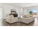 Spacious living room featuring contemporary sofas, stylish cabinet, and natural light, with views into adjacent rooms at 12246 E Agave Ln, Florence, AZ 85132