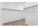 Large walk-in closet features wooden floors and metal racks ready for the organization of clothes at 12246 E Agave Ln, Florence, AZ 85132