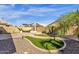 Spacious brick backyard features artificial grass, a grill, and beautiful palm trees at 1320 E Binner Dr, Chandler, AZ 85225