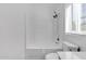 Bright bathroom featuring a shower-tub combo, toilet, and white tile surround at 1320 E Binner Dr, Chandler, AZ 85225