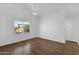 Bright bedroom featuring wood floors, a ceiling fan, and a scenic backyard view at 1320 E Binner Dr, Chandler, AZ 85225