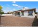 Backyard view of home exterior with large gravel area at 14112 N 12Th St, Phoenix, AZ 85022