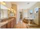 Luxury bathroom with double vanity, granite countertops, and a separate tub and shower at 14112 N 12Th St, Phoenix, AZ 85022