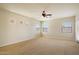 Bright and airy bedroom with large windows, neutral carpet, and a ceiling fan at 14112 N 12Th St, Phoenix, AZ 85022