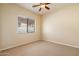 Bedroom with neutral carpet and window with blinds, offering natural light at 14112 N 12Th St, Phoenix, AZ 85022