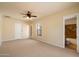 Spacious bedroom featuring a ceiling fan and ensuite bathroom access at 14112 N 12Th St, Phoenix, AZ 85022
