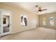 Large bedroom with neutral walls, ceiling fan, carpet, and backyard view at 14112 N 12Th St, Phoenix, AZ 85022