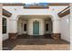 Inviting covered entryway featuring stone accents, archways, and a teal-colored front door at 14112 N 12Th St, Phoenix, AZ 85022