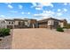Spacious home featuring desert landscaping, a paver driveway, and a three-car garage with custom doors at 14112 N 12Th St, Phoenix, AZ 85022