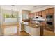 A gourmet kitchen featuring a large island with granite countertops, stainless appliances, and tile flooring at 14112 N 12Th St, Phoenix, AZ 85022