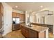 Spacious kitchen boasts stainless steel appliances, granite counters, a large island, and a wine fridge at 14112 N 12Th St, Phoenix, AZ 85022