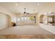 Bright living room features a ceiling fan, a fireplace, and large windows with a view to the yard at 14112 N 12Th St, Phoenix, AZ 85022