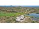 Expansive estate featuring a manicured golf course, private lake, and modern architecture at 15332 E Hidden Springs Trl, Fountain Hills, AZ 85268