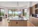 Modern kitchen with a large island, stainless steel appliances, and scenic views from expansive windows at 15332 E Hidden Springs Trl, Fountain Hills, AZ 85268