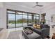 Spacious living room with comfortable seating, contemporary design, and picturesque views of the outdoor pool and mountains at 15332 E Hidden Springs Trl, Fountain Hills, AZ 85268