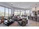 Bright, open-concept living room features large windows and access to an outdoor patio with dining and lounge furniture at 15332 E Hidden Springs Trl, Fountain Hills, AZ 85268
