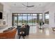 Stylish living room with sleek furnishings, offering seamless access to a pool and stunning views of the surrounding landscape at 15332 E Hidden Springs Trl, Fountain Hills, AZ 85268