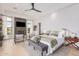 Bright main bedroom boasts a fireplace, television, seating area, and king bed with luxurious bedding at 15332 E Hidden Springs Trl, Fountain Hills, AZ 85268