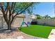 Backyard with artificial turf, play equipment, and well-maintained block wall at 162 W El Freda Rd, Tempe, AZ 85284