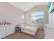 Comfortable bedroom features modern platform bed, TV, and a round window at 162 W El Freda Rd, Tempe, AZ 85284