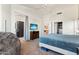 Bright bedroom with walk-in closet, TV and view to the bathroom with dark cabinets at 162 W El Freda Rd, Tempe, AZ 85284