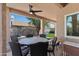 Inviting covered patio with a ceiling fan, outdoor dining set, and view of the backyard at 162 W El Freda Rd, Tempe, AZ 85284