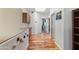Hallway with wood floors and a white accent wall with magnetic toys that leads to various rooms at 162 W El Freda Rd, Tempe, AZ 85284