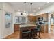 Well-lit kitchen showcasing an island with bar stools and stainless steel appliances, enhancing the home's appeal at 162 W El Freda Rd, Tempe, AZ 85284