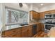 Sunlit kitchen featuring a sink beneath a window, complemented by stainless steel appliances, creating a welcoming atmosphere at 162 W El Freda Rd, Tempe, AZ 85284