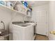 Bright laundry room with washer, dryer, and overhead shelving for storage at 162 W El Freda Rd, Tempe, AZ 85284