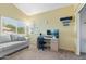 Bright office with a gray couch, a large window and a comfortable workspace with a modern monitor and desk at 162 W El Freda Rd, Tempe, AZ 85284