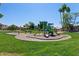 A spacious playground with swings, slides, and climbing structures on a lush green lawn at 162 W El Freda Rd, Tempe, AZ 85284