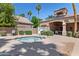 Community spa and outdoor seating area with tile roof, chairs, and lush landscaping at 162 W El Freda Rd, Tempe, AZ 85284