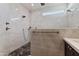 Contemporary shower featuring pebble floor and grey tile accent wall, adding a spa-like feel to the bathroom at 162 W El Freda Rd, Tempe, AZ 85284
