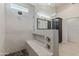 Modern bathroom shower with stone floor, marble walls, a built-in bench, and glass surround at 162 W El Freda Rd, Tempe, AZ 85284