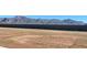 Empty backyard with a perimeter privacy wall and mountain views at 17247 W Daley Ln, Surprise, AZ 85387