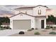 Charming two-story home featuring a neutral color scheme, tile roof, and a well-manicured, low maintenance front yard at 17247 W Daley Ln, Surprise, AZ 85387