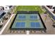 Aerial view of the community pickleball courts with a basketball hoop, and manicured landscaping at 17247 W Daley Ln, Surprise, AZ 85387