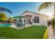 Lush backyard with artificial turf, pool, BBQ grill, and outdoor dining area for ultimate outdoor relaxation at 18001 N 44Th Way, Phoenix, AZ 85032