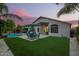 Expansive backyard with a sparkling pool, lush greenery, outdoor seating, and ample space for entertaining at 18001 N 44Th Way, Phoenix, AZ 85032