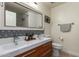 Modern bathroom features a double sink vanity, decorative tile backsplash, and a framed mirror at 18001 N 44Th Way, Phoenix, AZ 85032