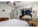This bedroom features hardwood floors, a ceiling fan, and a mirrored closet at 18001 N 44Th Way, Phoenix, AZ 85032