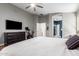 Comfortable bedroom featuring ceiling fan, dresser, and doorway to closet at 18001 N 44Th Way, Phoenix, AZ 85032