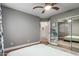 Cozy bedroom with hardwood floors, ceiling fan, and a mirrored closet at 18001 N 44Th Way, Phoenix, AZ 85032