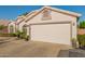 Charming home exterior featuring a two-car garage, tile roof, manicured landscaping, and attractive curb appeal at 18001 N 44Th Way, Phoenix, AZ 85032